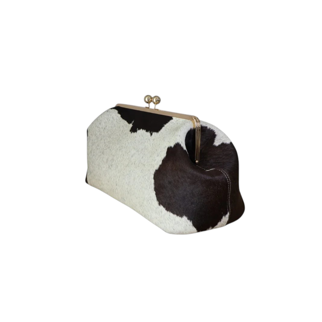 Jesalin Sette extra large structured pouch in black and white cow print hair-on leather with a gold kiss-lock clasp.