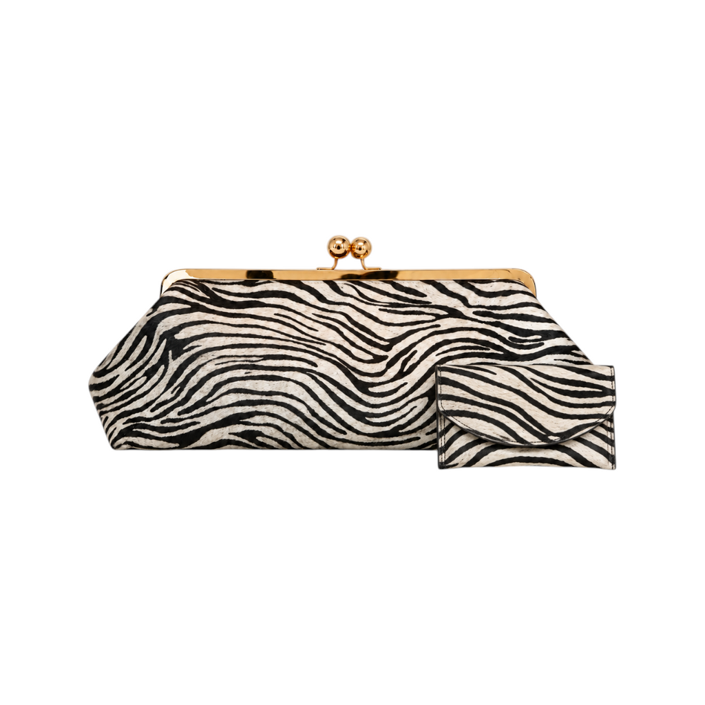 Jesalin Sette Lungo clutch in zebra-print cowhide leather with a gold kisslock closure and matching small wallet.