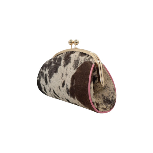 Jesalin Aluna handbag in cow print hair-on hide with pink leather trim and gold kiss lock frame