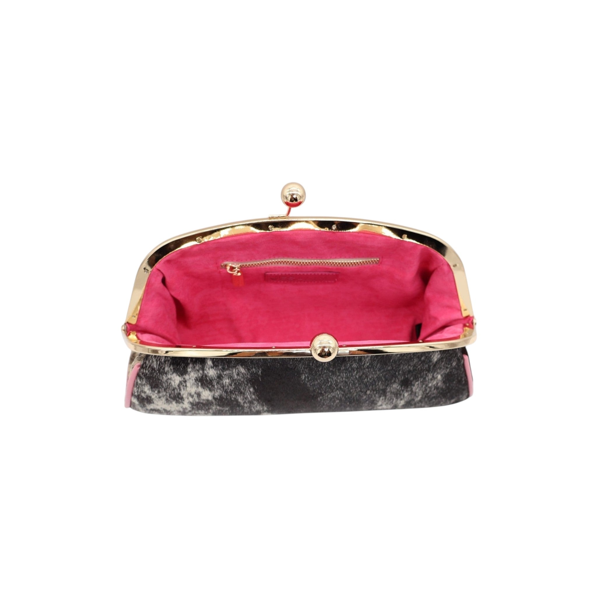 Jesalin Aluna handbag in cow print hair-on hide with pink leather trim, gold kiss lock frame, and hot pink interior.