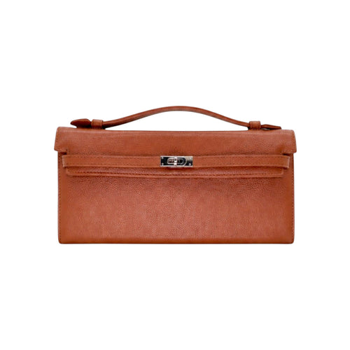Jesalin Angelo camel clutch in grained bovine leather with a classic elongated silhouette and silver metal clasp.