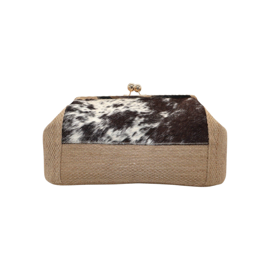 Jesalin Sette handbag featuring natural jute, cow print hair-on hide, and a gold kiss lock frame.