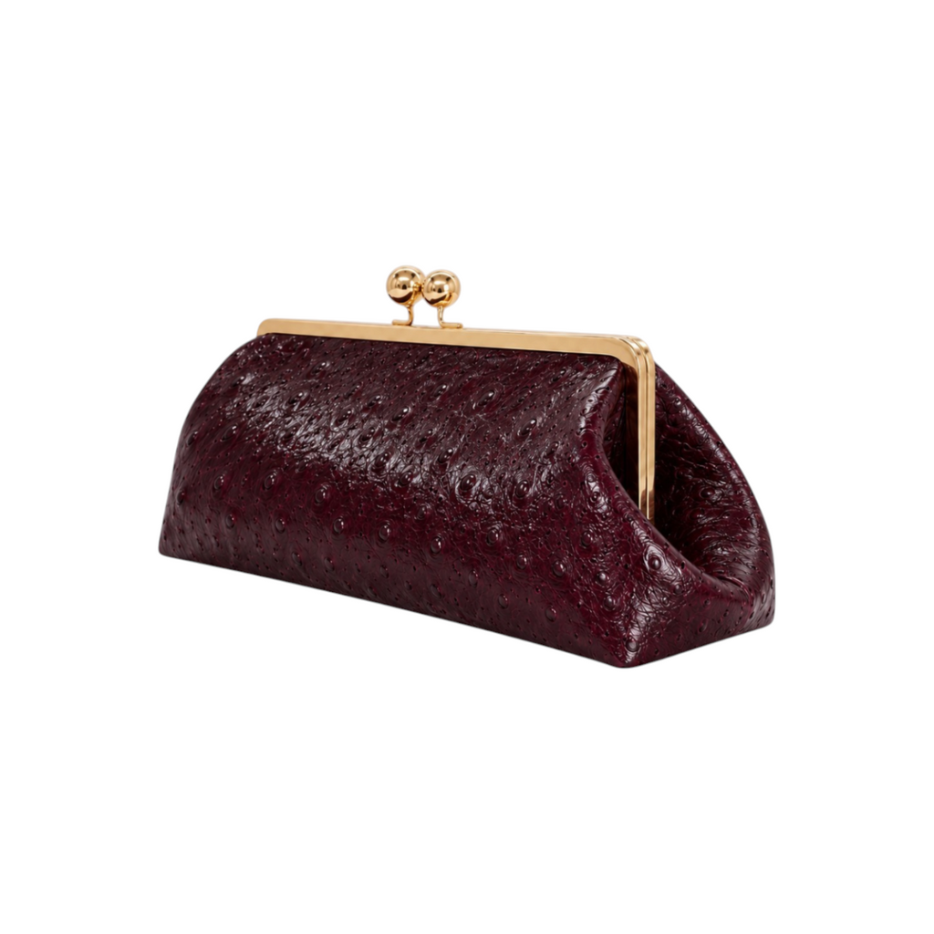 Jesalin Sette Lungo clutch in burgundy ostrich-embossed leather with a gold kisslock closure on a white background.